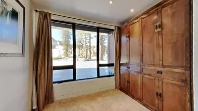 a room with a large window and wooden cabinets at 1849 Condos 103 home in Mammoth Lakes