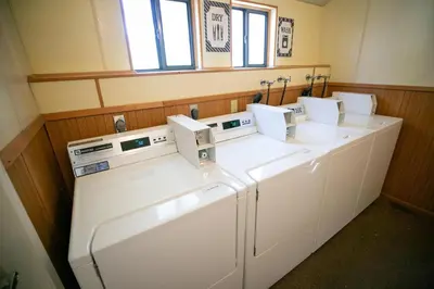 a row of washers and dryers in a utility room at 1849 Condos 103 home in Mammoth Lakes