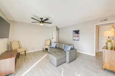 a living room with a couch and a ceiling fan at Cozy Fresno Condo with Balcony and Pool Access in Fresno
