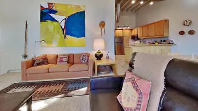 a living room with a couch and a kitchen at 1849 Condos 631 home in Mammoth Lakes