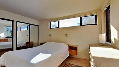 a bedroom with two beds and two windows at 1849 Condos 631 home in Mammoth Lakes
