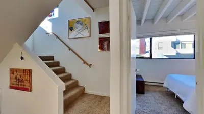 a room with a staircase with a bed and a window at 1849 Condos 631 home in Mammoth Lakes