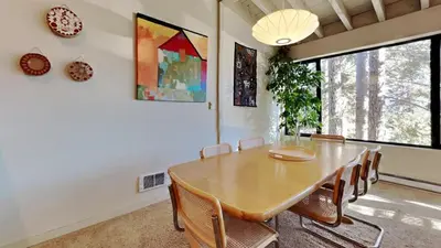 a dining room with a wooden table and chairs at 1849 Condos 631 home in Mammoth Lakes
