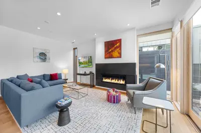 a living room with a blue couch and a fireplace at Stellar Ski-in Ski-out Out # 2 at Northstar 2 by Tahoe Getaways - Pet-Friendly 3BR Townhome w Loft, Shuttle and HOA! in Truckee-Tahoe Airport