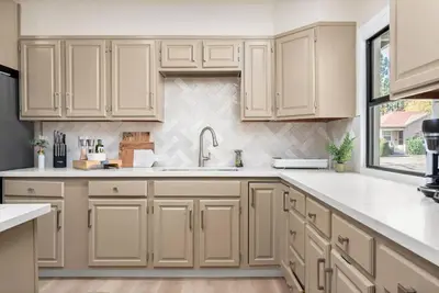 a kitchen with white cabinets and a sink at Downtown Lodi l Renovated l 5 Bedrooms l Sleeps 10 in Lodi