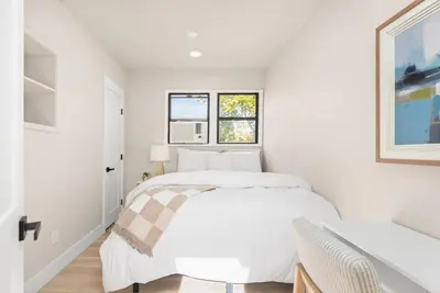 a white bedroom with a white bed and a window at Downtown Lodi l Renovated l 5 Bedrooms l Sleeps 10 in Lodi