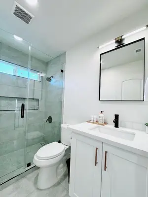 a bathroom with a toilet and a sink and a shower at Trendy Trenholm in Elk Grove