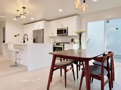 a kitchen with a wooden table and chairs in a kitchen at Trendy Trenholm in Elk Grove