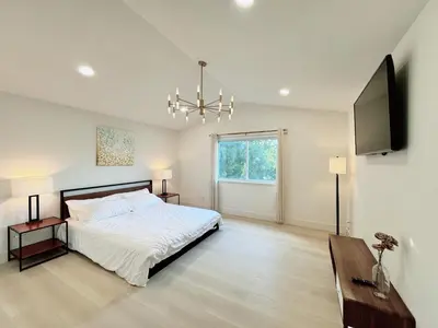 a bedroom with a bed and a television and a table at Trendy Trenholm in Elk Grove