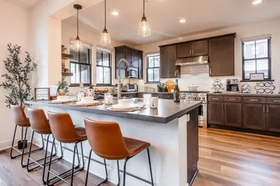 a kitchen with a large island with bar stools at Creekhouse 1364 in Mammoth Lakes