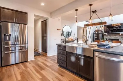 a kitchen with stainless steel appliances and wood floors at Creekhouse 1364 in Mammoth Lakes