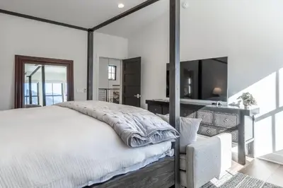 a bedroom with a large bed and a television at Creekhouse 1364 in Mammoth Lakes