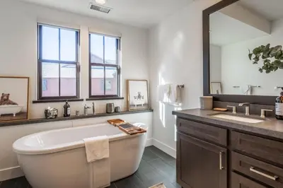 a bathroom with a large tub and a large mirror at Creekhouse 1364 in Mammoth Lakes
