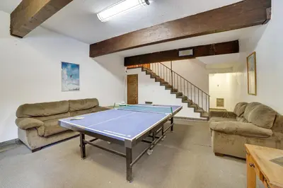 a room with a ping pong table and couches at Mammoth Lakes Condo Walk to Village and Gondola! in Mammoth Lakes