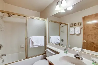 a bathroom with a tub and a sink and a shower at Mammoth Lakes Condo Walk to Village and Gondola! in Mammoth Lakes