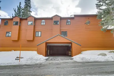 a large orange building with a garage at Mammoth Lakes Condo Walk to Village and Gondola! in Mammoth Lakes