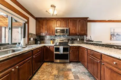 a kitchen with wooden cabinets and stainless steel appliances at 4BD Lakeside Retreat with Views in Tahoe City