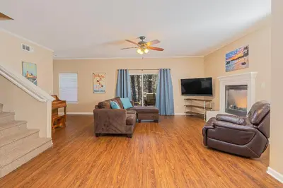 a living room with furniture and a ceiling fan at Yosemite Bass Lake Adventure Oasis in Bass Lake