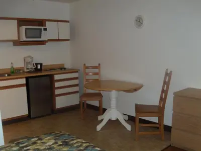 a small kitchen with a table and chairs in a room at Corral Creek Lodge in Kernville
