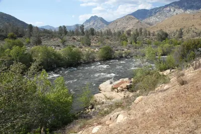 a river in the middle of a valley with mountains at Corral Creek Lodge in Kernville