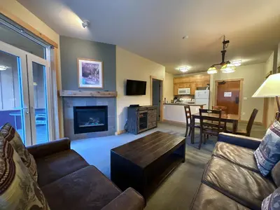 a living room with a couch and a fireplace at Ski-in/Ski-out with views at Sunstone in Mammoth Lakes