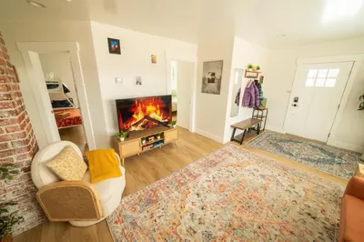 a living room with a fire in the fireplace at Reno's Biggest Little House - Cozy Home Theatre in Reno