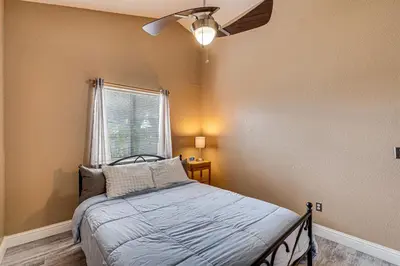 a bedroom with a bed and a ceiling fan at Cozy Antelope Home about 14 Mi to Sacramento! in Antelope