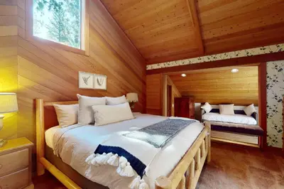 a bedroom with a bed in a log cabin at Timberline Daydream in Truckee