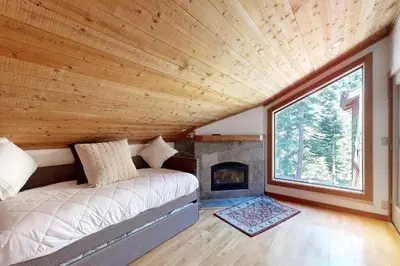 a living room with a couch and a fireplace at Timberline Daydream in Truckee