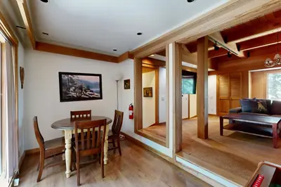 a dining room with a table and a couch at Timberline Daydream in Truckee
