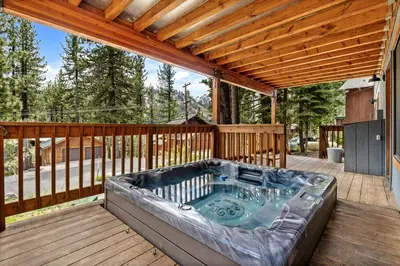 a hot tub on the deck of a house at Trailblazer Chalet at Olympic Valley with Private Hot Tub and Ski Shuttle in Alpine Meadows