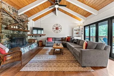 a living room with a couch and a fireplace at Trailblazer Chalet at Olympic Valley with Private Hot Tub and Ski Shuttle in Alpine Meadows
