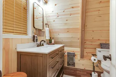 a bathroom with a sink and a toilet at 3 Mi to Calaveras Big Trees Cabin with Fire Pit! in Arnold