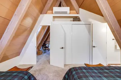 a room with a white cabinet in a attic at 3 Mi to Calaveras Big Trees Cabin with Fire Pit! in Arnold