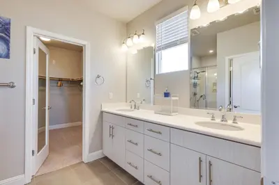 a bathroom with two sinks and a large mirror at Stylish Lodi Wine Country Retreat with Private Patio in Lodi