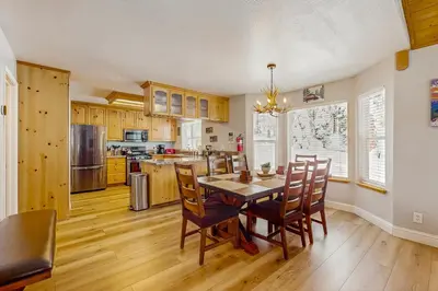 a kitchen with a dining room table and chairs at A Taste of Tahoe in Tahoe Vista