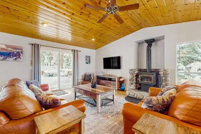 a living room with leather furniture and a wood stove at A Taste of Tahoe in Tahoe Vista