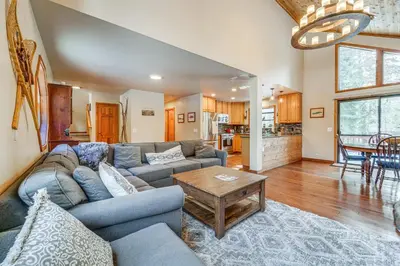 a living room with a couch and a table at Family Cabin with Community Perks in Truckee! in Truckee