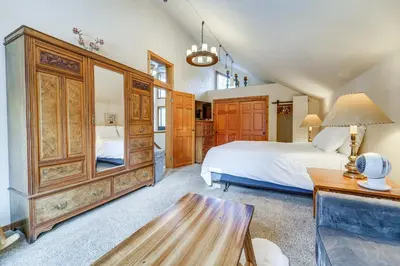 a bedroom with a bed and a wooden cabinet at Family Cabin with Community Perks in Truckee! in Truckee