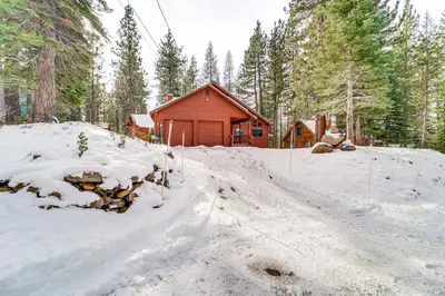 a snow covered road in front of a cabin at Family Cabin with Community Perks in Truckee! in Truckee