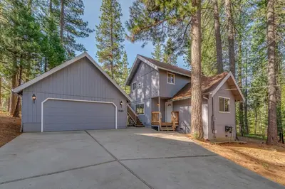 a large house with a garage in the woods at Ravenhill in Arnold