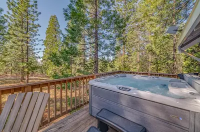 a hot tub on a deck with a chair at Ravenhill in Arnold
