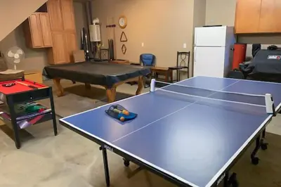 a ping pong table in the middle of a room at Peaceful Pinecone in Dorrington