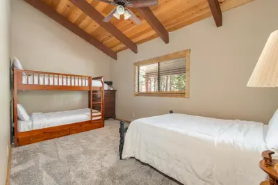 a bedroom with two bunk beds and a window at Peaceful Pinecone in Dorrington