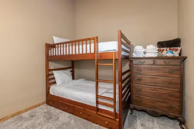 a bedroom with two bunk beds and a dresser at Peaceful Pinecone in Dorrington
