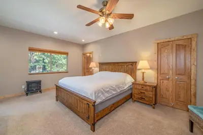 a bedroom with a bed and a ceiling fan at Peaceful Pinecone in Dorrington
