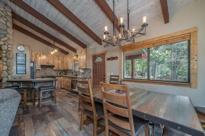 a dining room and kitchen with a table and chairs at Peaceful Pinecone in Dorrington