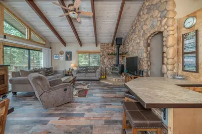 a living room with a large stone wall at Peaceful Pinecone in Dorrington