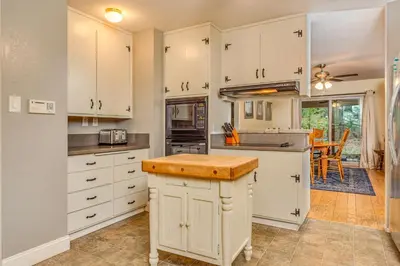 a kitchen with white cabinets and a counter top at Oso Borracho in Arnold