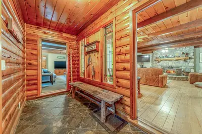 a log cabin with a bench in a room at Oso Borracho in Arnold